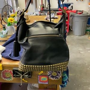 Coach Hobo Black bag with gold rivets on base.